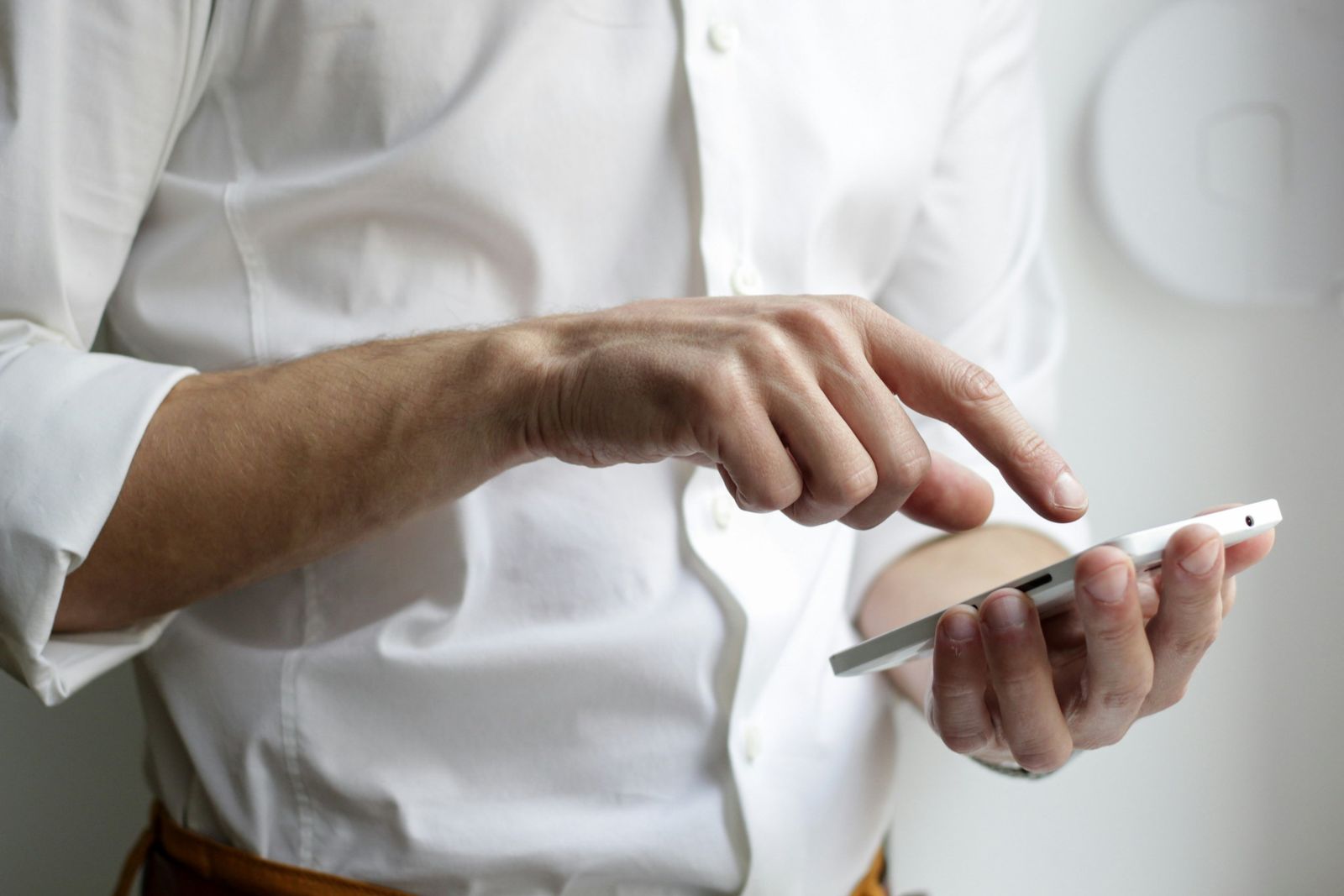 Someone tapping the screen of a phone